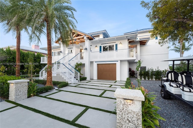 view of front of home with a garage and a balcony