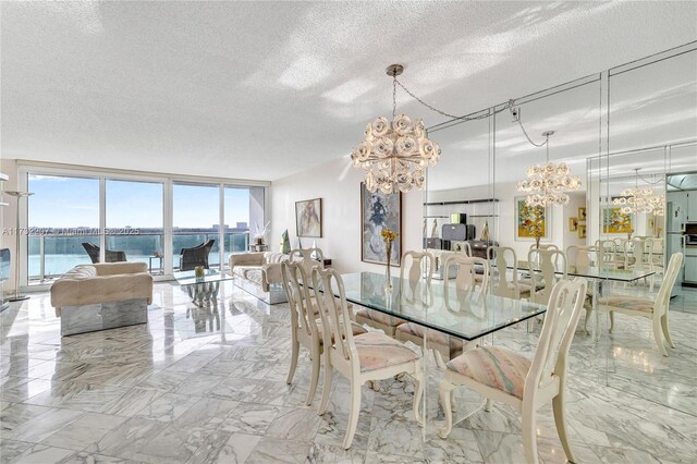 dining space with expansive windows, a water view, a textured ceiling, and an inviting chandelier