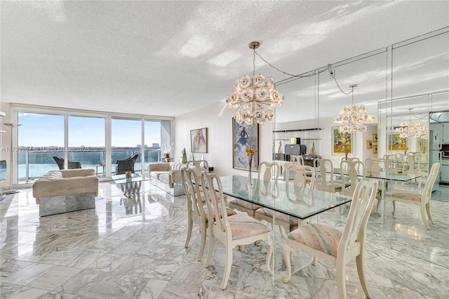 dining space featuring expansive windows, a water view, a notable chandelier, and a textured ceiling