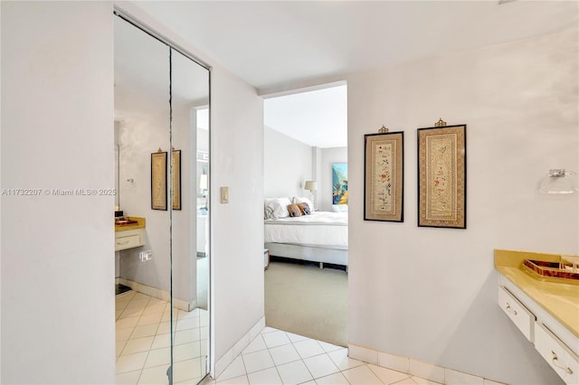 bedroom with a closet and light tile patterned floors