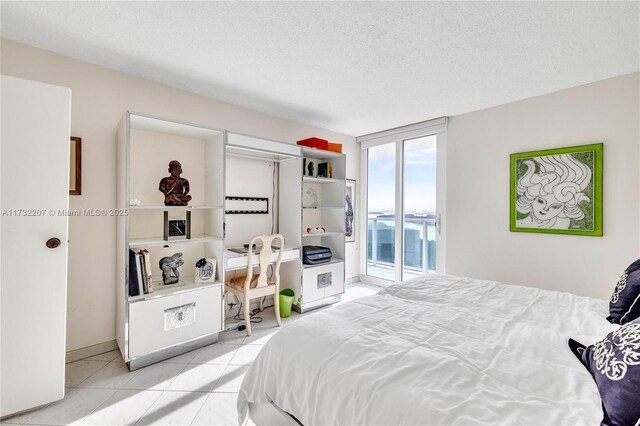 bedroom featuring access to outside and a textured ceiling