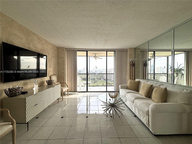 tiled living room featuring a wall of windows and a textured ceiling