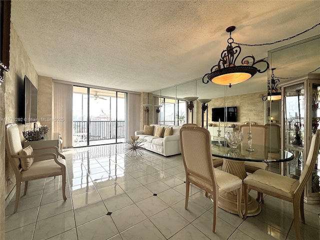 dining space featuring expansive windows, plenty of natural light, a textured ceiling, and light tile patterned floors