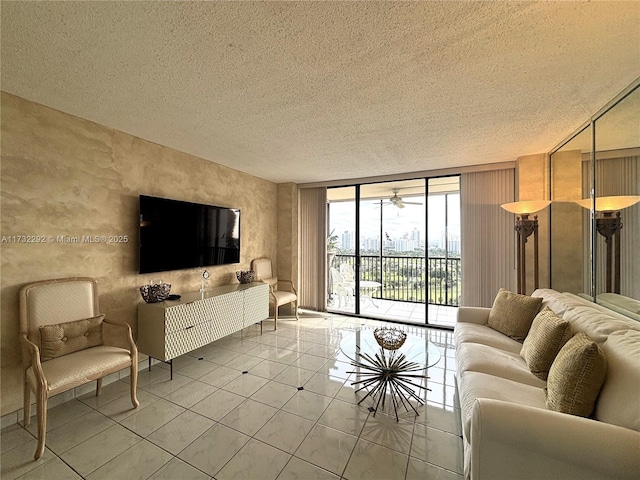 tiled living room featuring a wall of windows and a textured ceiling