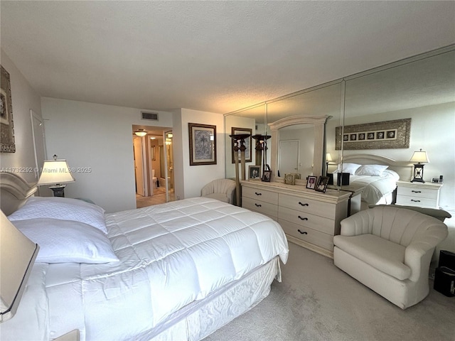 carpeted bedroom featuring a textured ceiling and a closet