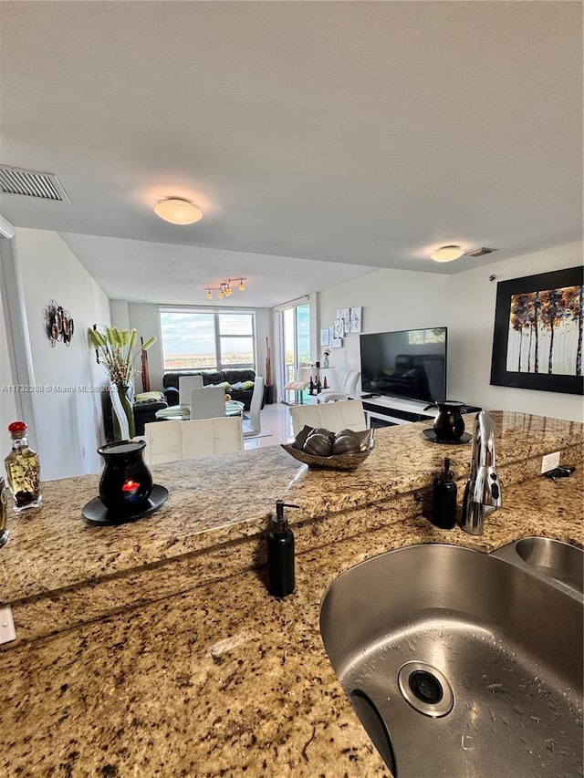 kitchen with sink and light stone countertops