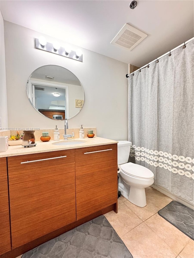 bathroom with vanity, tile patterned floors, and toilet