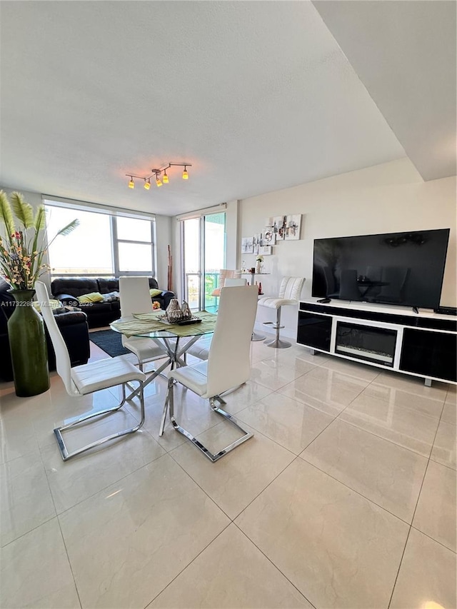 living room with track lighting and light tile patterned floors