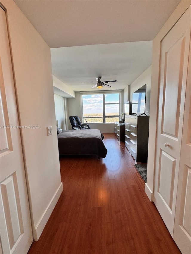 bedroom featuring dark hardwood / wood-style flooring and ceiling fan