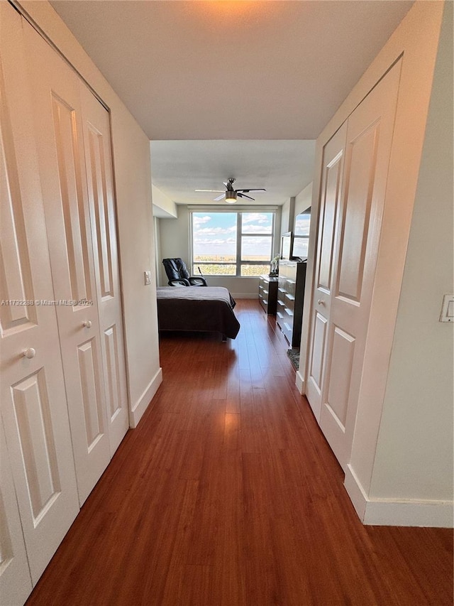 corridor with dark hardwood / wood-style floors