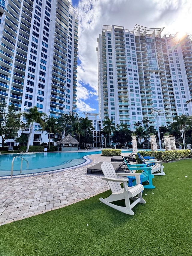 view of swimming pool featuring a patio area and a lawn