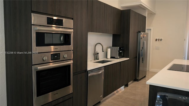 kitchen with sink, dark brown cabinets, and stainless steel appliances