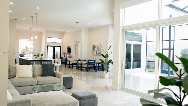 living room featuring a high ceiling, ornamental molding, and french doors