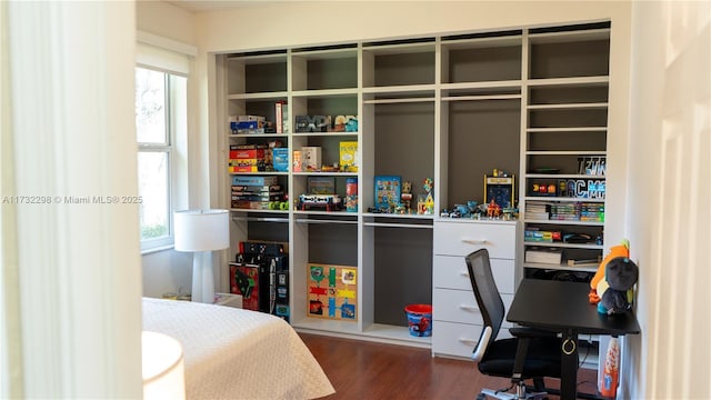 bedroom with dark hardwood / wood-style floors