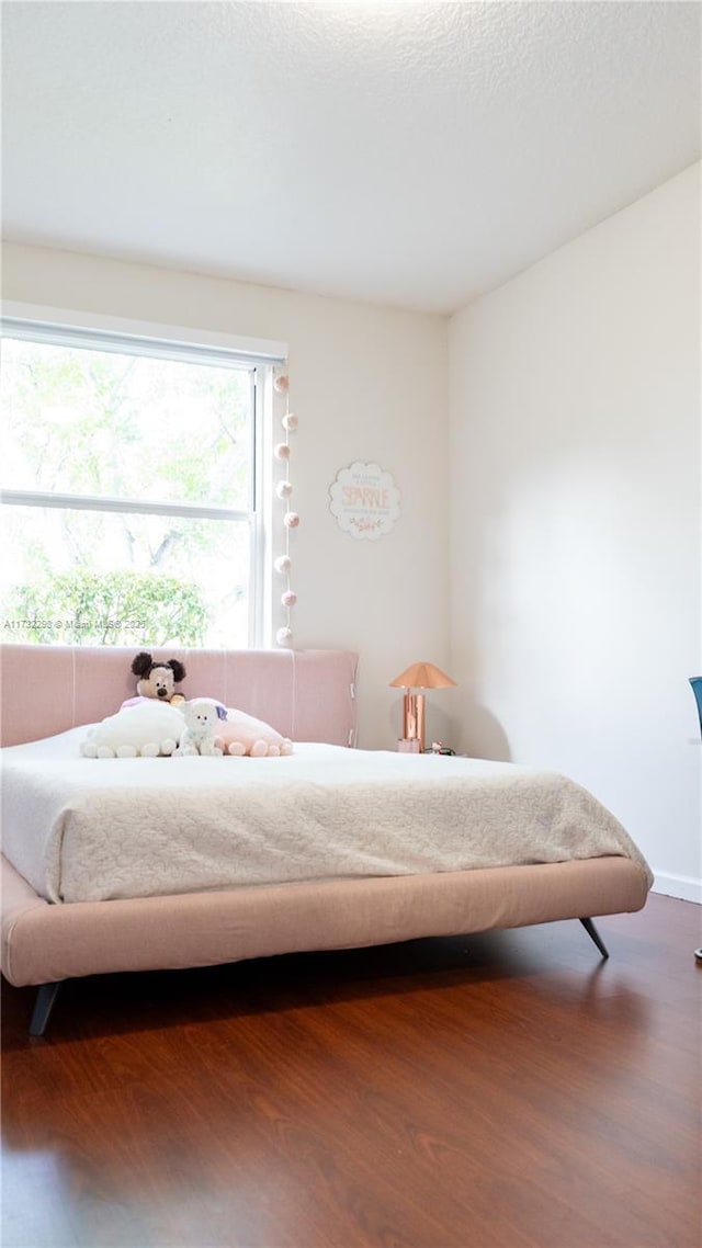 bedroom with wood-type flooring