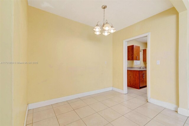 tiled spare room featuring a wealth of natural light and ceiling fan