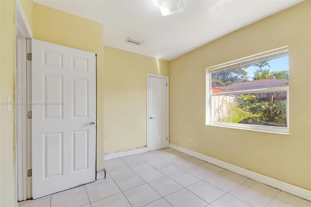 unfurnished bedroom with light tile patterned floors