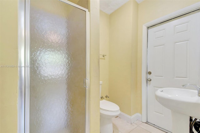 bathroom with walk in shower, sink, toilet, and tile patterned flooring