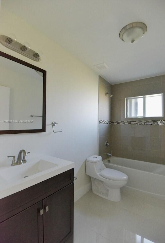 full bathroom with tiled shower / bath, vanity, and toilet