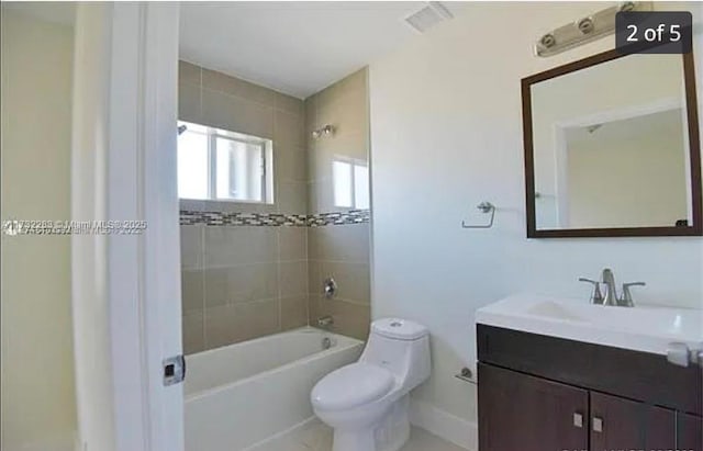 full bathroom with vanity, tiled shower / bath combo, and toilet