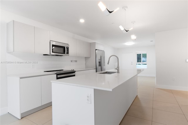 2555 NE 193rd St Unit 2102, Miami, FL 33180 - kitchen with white cabinetry, hanging light fixtures, an island with sink, and appliances with stainless steel finishes