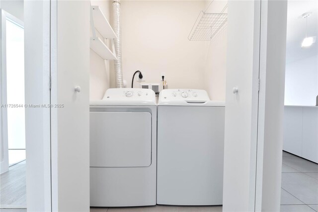 2555 NE 193rd St Unit 2102, Miami, FL 33180 - laundry room featuring separate washer and dryer and light tile patterned flooring