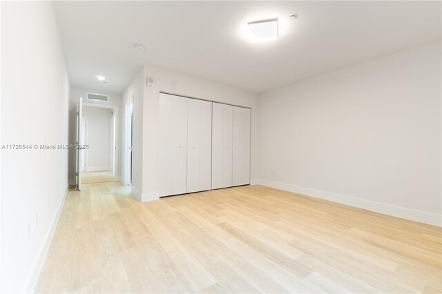 2555 NE 193rd St Unit 2102, Miami, FL 33180 - unfurnished bedroom with a closet and light hardwood / wood-style flooring