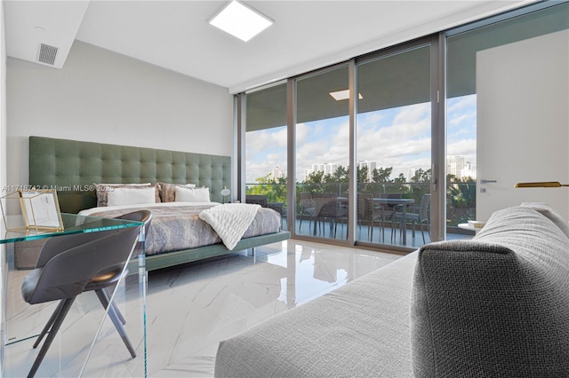 bedroom featuring a wall of windows and access to exterior