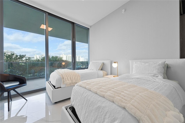 bedroom with expansive windows and access to exterior