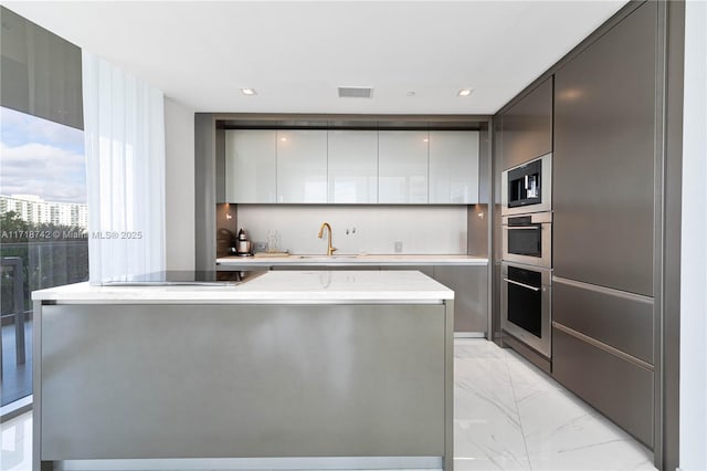 kitchen with stainless steel appliances, a center island, and sink