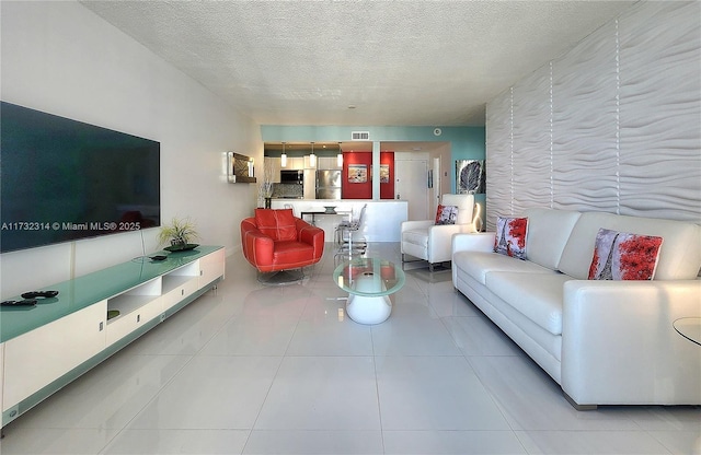 3505 S Ocean Dr Unit 1011, Hollywood, FL 33019 - living area featuring visible vents, tile patterned floors, and a textured ceiling