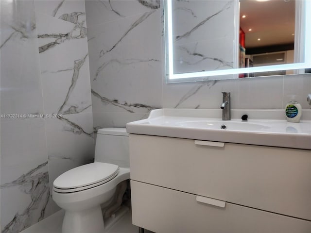 3505 S Ocean Dr Unit 1011, Hollywood, FL 33019 - bathroom featuring toilet, vanity, and tile walls