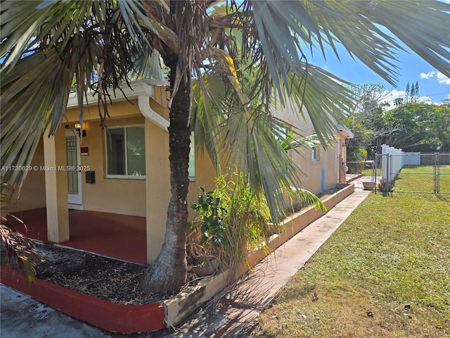 view of side of home with a lawn