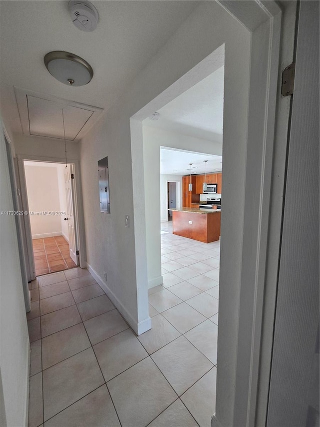 hall featuring light tile patterned flooring