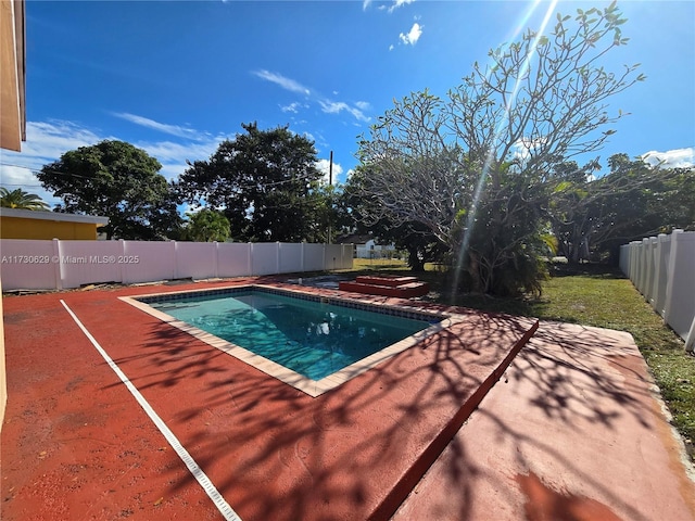 view of swimming pool with a patio