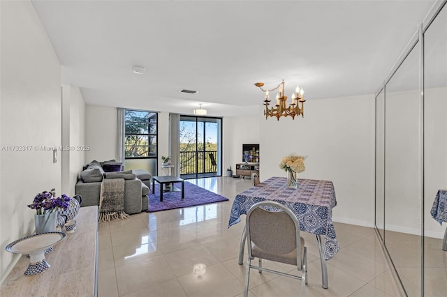 tiled dining area featuring a notable chandelier