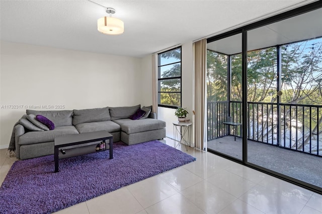 tiled living room featuring floor to ceiling windows