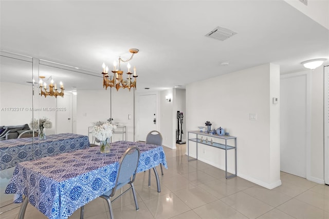 tiled dining room featuring a chandelier