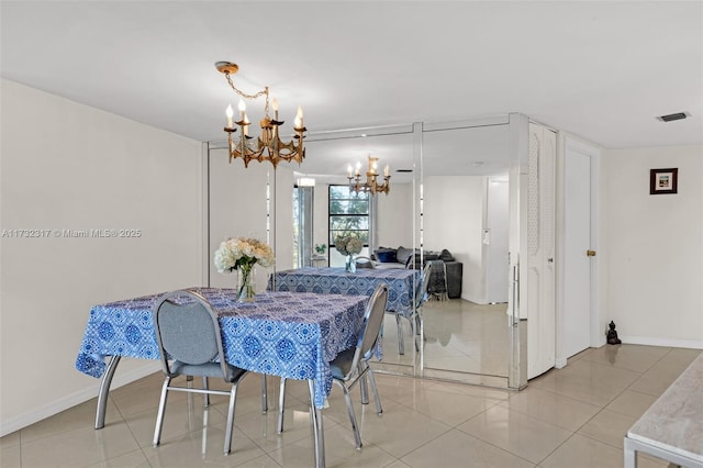 dining room featuring an inviting chandelier and light tile patterned floors