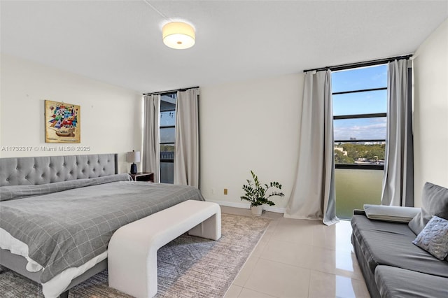 tiled bedroom with floor to ceiling windows