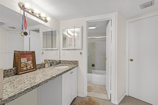 bathroom featuring tile patterned floors, combined bath / shower with glass door, and vanity