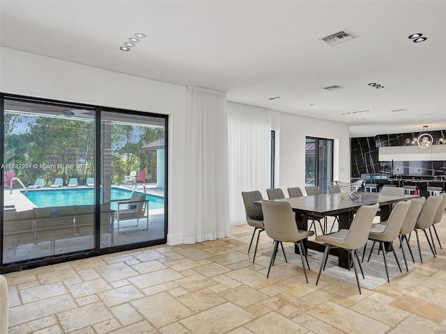 dining area featuring visible vents and stone tile floors