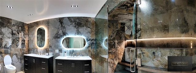 bathroom with a sink, tile walls, and two vanities