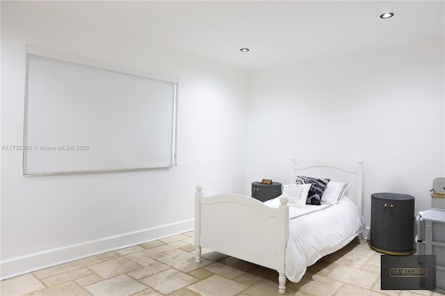 bedroom featuring recessed lighting, baseboards, and stone tile floors