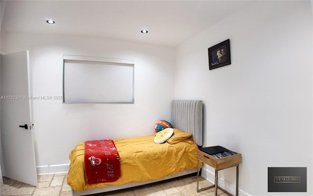 bedroom featuring baseboards, stone tile flooring, and recessed lighting