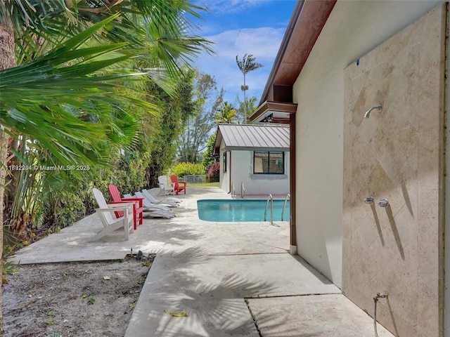 view of swimming pool featuring a patio area and a fenced in pool