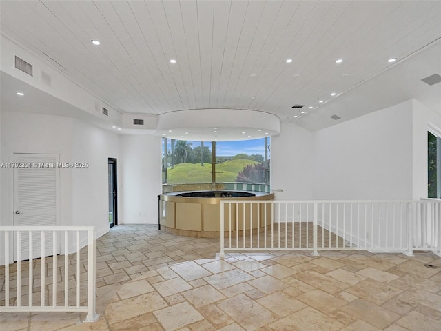 unfurnished room featuring wood ceiling, stone tile floors, visible vents, and recessed lighting