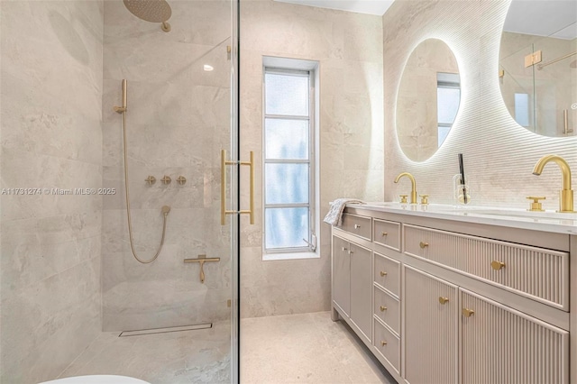 bathroom with vanity and tiled shower