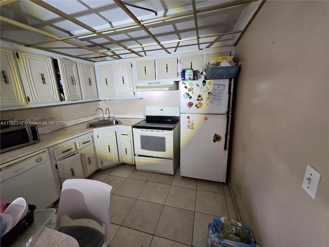 kitchen featuring light tile patterned floors, white appliances, and sink