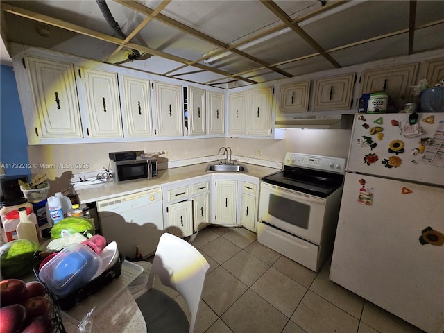 kitchen featuring sink, light tile patterned floors, and white appliances